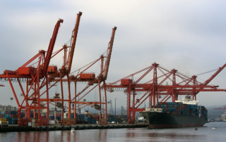 Cranes,Unloading,Containers,From,Cargo,Ship,At,Seattle,Seaport,,Usa