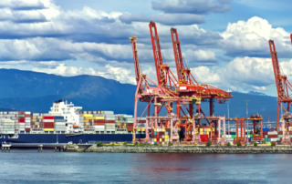 Container,Ship,In,Vancouver,Port,,Red,Sea,Cranes,And,Colorful